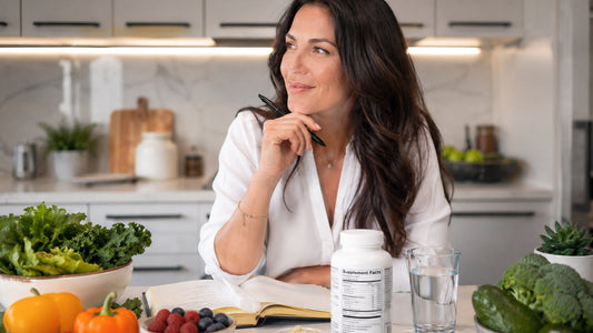 Woman planning a gut-friendly nutrition strategy with fiber-rich foods and appetite control supplements in a modern kitchen.